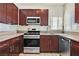 Updated kitchen features stainless steel appliances, granite counters, tile backsplash and modern fixtures at 1830 N Buffalo Dr # 2106, Las Vegas, NV 89128