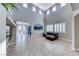 Open-concept living room with soaring ceilings, tiled floors, and views into the blue kitchen at 184 Timeless View Ct, Henderson, NV 89012