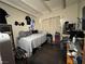 Simple bedroom featuring neutral walls, dark wood floors, and a window for natural light and ventilation at 2043 Donna St, North Las Vegas, NV 89030