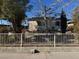 Inviting single-Gathering house with a white picket fence and established greenery at 2043 Donna St, North Las Vegas, NV 89030