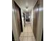 Hallway features tile flooring, with doors on either side leading to various rooms in the home at 2043 Donna St, North Las Vegas, NV 89030