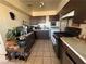 Functional kitchen featuring appliances, tile flooring, and ample cabinet space at 2043 Donna St, North Las Vegas, NV 89030