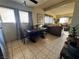 Open living room featuring dining set, tile flooring, and comfortable seating at 2043 Donna St, North Las Vegas, NV 89030