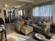 Open living room and dining area featuring tile floors, neutral colors, and natural light from large windows at 2043 Donna St, North Las Vegas, NV 89030