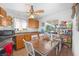 Bright kitchen featuring wooden cabinets, a ceiling fan, and an adjacent breakfast nook with a white table at 2229 La Puente St, Las Vegas, NV 89115