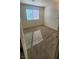 A cozy bedroom offers natural light and neutral carpeting at 2734 Champagne Gold Ave, North Las Vegas, NV 89086