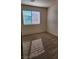 A cozy bedroom offers natural light and neutral carpeting at 2734 Champagne Gold Ave, North Las Vegas, NV 89086