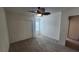 Comfortable bedroom featuring carpet floors, closet, and a stylish ceiling fan at 2734 Champagne Gold Ave, North Las Vegas, NV 89086