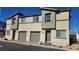 Exterior of a two-story home with neutral siding, a one-car garage, and desert landscaping at 2734 Champagne Gold Ave, North Las Vegas, NV 89086