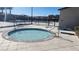 Community hot tub with safety railings and tiled surroundings on a sunny day at 2734 Champagne Gold Ave, North Las Vegas, NV 89086