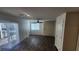 Bright living room with wood-look floors, a ceiling fan, and access to a private outdoor space at 2734 Champagne Gold Ave, North Las Vegas, NV 89086