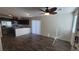 Open-concept living room featuring wood floors, modern lighting, and access to the kitchen and outdoor spaces at 2734 Champagne Gold Ave, North Las Vegas, NV 89086
