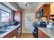 Galley kitchen features wood cabinets, granite countertops, and stainless steel dishwasher at 2750 S Durango Dr # 2012, Las Vegas, NV 89117