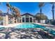 Community swimming pool surrounded by palm trees, lounge chairs, and pergola at 2750 S Durango Dr # 2012, Las Vegas, NV 89117