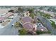 Expansive aerial view of a two-story home with a pool, manicured lawn, and a tile roof in a quiet neighborhood at 3341 Camino Gardens Way, Las Vegas, NV 89146