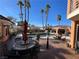 Luxurious backyard with a sparkling pool, palm trees, and patio seating for outdoor entertaining at 3341 Camino Gardens Way, Las Vegas, NV 89146