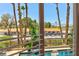 Palm-lined balcony with a view of the pool area and neighborhood, offers outdoor enjoyment at 3341 Camino Gardens Way, Las Vegas, NV 89146