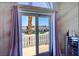 Balcony doors with light purple drapes open to a scenic neighborhood view at 3341 Camino Gardens Way, Las Vegas, NV 89146