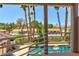 Balcony view overlooking a pool with palm trees, providing a serene outdoor living experience at 3341 Camino Gardens Way, Las Vegas, NV 89146