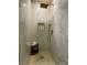 Walk-in shower with marble-look tile, a rainfall showerhead, and a built-in niche for toiletries on a tiled floor at 3341 Camino Gardens Way, Las Vegas, NV 89146