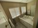Well-lit bathroom featuring a large mirror and stylish geometric flooring at 3341 Camino Gardens Way, Las Vegas, NV 89146