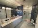 A bathroom featuring a large mirror above a double vanity with a glass enclosed shower on a tiled floor at 3341 Camino Gardens Way, Las Vegas, NV 89146