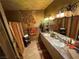 Well-lit bathroom showcasing double sinks, tiled floors, and decorative towels at 3341 Camino Gardens Way, Las Vegas, NV 89146
