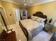 A bedroom features an ornate, carved wood headboard with beige and gold bedding, offering a luxurious ambiance at 3341 Camino Gardens Way, Las Vegas, NV 89146