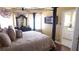 A bedroom featuring a four poster bed, luxurious bedding and an adjacent bathroom at 3341 Camino Gardens Way, Las Vegas, NV 89146
