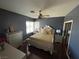 A bedroom features black painted walls with gold accents from the mirror and pillows to the luxurious bedding at 3341 Camino Gardens Way, Las Vegas, NV 89146