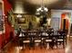 Formal dining room featuring chandelier lighting and table, accented by decorative wall details at 3341 Camino Gardens Way, Las Vegas, NV 89146