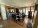Bright dining room has an elegant chandelier and a dark wood table with six chairs at 3341 Camino Gardens Way, Las Vegas, NV 89146