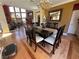 This bright dining area features a beautiful chandelier and dark wood table with six chairs at 3341 Camino Gardens Way, Las Vegas, NV 89146