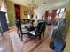 Elegant dining room features a chandelier, dark wood table and chairs, and hardwood floors at 3341 Camino Gardens Way, Las Vegas, NV 89146