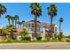 Charming two-story home with a red tile roof, mature palm trees, and a well-maintained lawn at 3341 Camino Gardens Way, Las Vegas, NV 89146