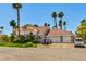 Inviting two-story home with a three-car garage, mature palm trees, and a well-manicured lawn at 3341 Camino Gardens Way, Las Vegas, NV 89146