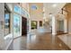 A grand foyer with a curved staircase, high ceilings, and lots of natural light at 3341 Camino Gardens Way, Las Vegas, NV 89146