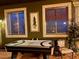 A spacious game room is shown with an air hockey table and a decorative chair at 3341 Camino Gardens Way, Las Vegas, NV 89146