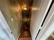 Hallway with wooden steps leads downward and is illuminated by decorative hanging lights at 3341 Camino Gardens Way, Las Vegas, NV 89146