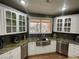 Well-lit kitchen featuring stainless steel appliances, modern sink, tile backsplash, and white cabinetry at 3341 Camino Gardens Way, Las Vegas, NV 89146
