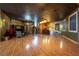Spacious living room featuring wood floors, recessed lighting, and a wet bar perfect for entertaining at 3341 Camino Gardens Way, Las Vegas, NV 89146