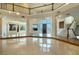 Spacious living room with marble floors, grand staircase, and ample natural light at 3341 Camino Gardens Way, Las Vegas, NV 89146