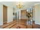 Living room featuring wood and marble floors, chandelier and a staircase at 3341 Camino Gardens Way, Las Vegas, NV 89146