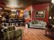 This large living room features a couch and dining area with unique brick-like accents on the walls at 3341 Camino Gardens Way, Las Vegas, NV 89146