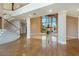 Open-concept living room with hardwood floors, high ceilings, and a fireplace at 3341 Camino Gardens Way, Las Vegas, NV 89146