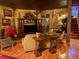 Cozy living room with hardwood floors, unique decor, and plenty of seating at 3341 Camino Gardens Way, Las Vegas, NV 89146