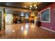 Expansive living space featuring hardwood floors, elegant lighting, and unique decor at 3341 Camino Gardens Way, Las Vegas, NV 89146