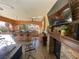 Outdoor fireplace and bar area features ample seating, a grill, and a mounted television at 3341 Camino Gardens Way, Las Vegas, NV 89146
