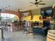 Covered outdoor bar area with a fireplace, TV, and ample seating for relaxing and entertaining at 3341 Camino Gardens Way, Las Vegas, NV 89146