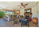 Covered outdoor kitchen with a stone fireplace, stainless steel appliances, and barstool seating at 3341 Camino Gardens Way, Las Vegas, NV 89146